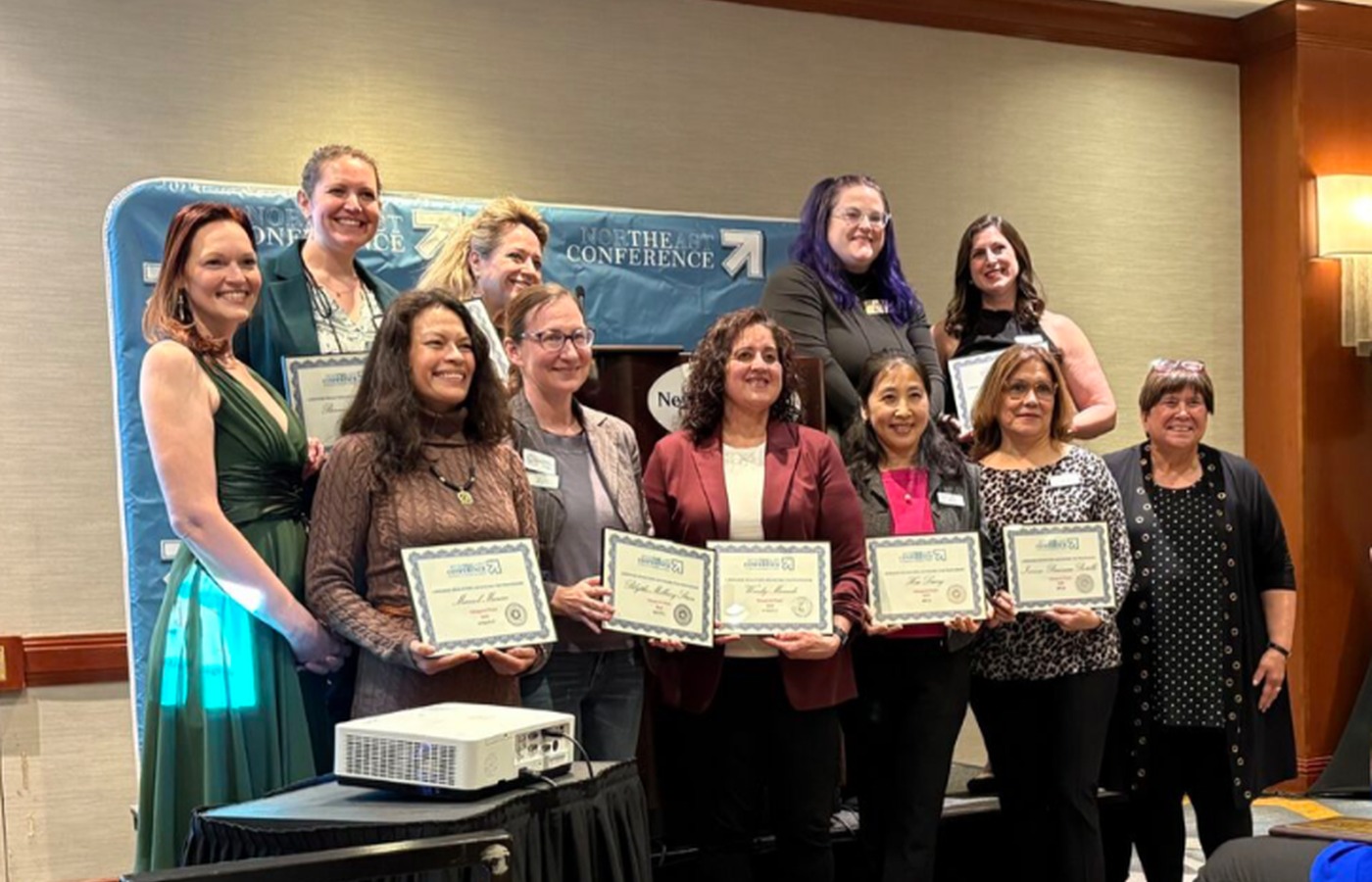 Inaugural NECTFL LEAP leadership cohort holding completion certificates