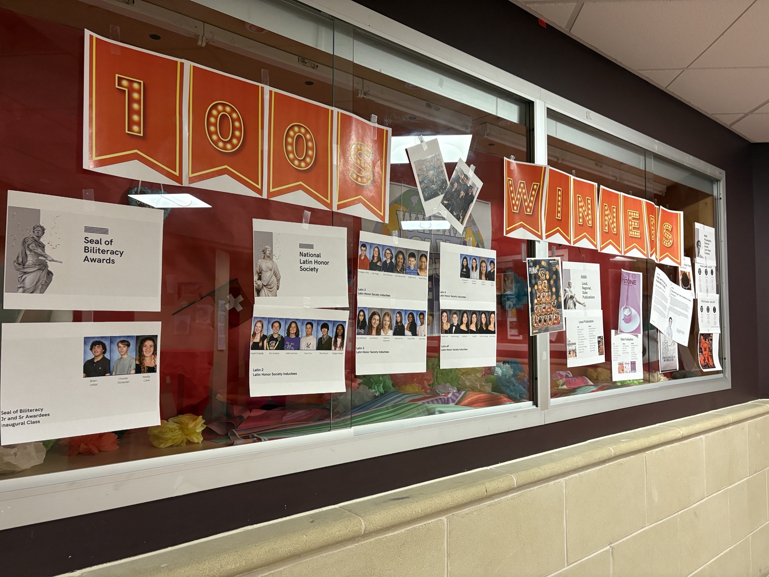 Hallway display documenting student awards and publications